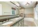 Bathroom featuring double sink vanity, large mirror, tub, and tiled shower at 7801 Wood Way Ct, Raleigh, NC 27606