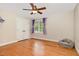 Bedroom with hardwood floors, closet, and large window at 7801 Wood Way Ct, Raleigh, NC 27606