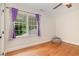 Bedroom featuring hardwood floors and a bright window at 7801 Wood Way Ct, Raleigh, NC 27606
