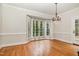 Elegant dining room with hardwood floors, chandelier, and bay window at 7801 Wood Way Ct, Raleigh, NC 27606
