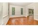 Bright dining room with hardwood floors and natural light from large windows at 7801 Wood Way Ct, Raleigh, NC 27606