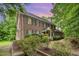 Charming two-story brick home with blue shutters surrounded by lush greenery at 7801 Wood Way Ct, Raleigh, NC 27606