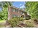 Charming two-story brick home with blue shutters surrounded by lush greenery at 7801 Wood Way Ct, Raleigh, NC 27606