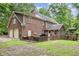 Brick home featuring a backyard gazebo, brick patio, and 2-car garage at 7801 Wood Way Ct, Raleigh, NC 27606