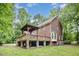 Charming brick home with a large wooden deck, perfect for outdoor entertaining and enjoying the serene surroundings at 7801 Wood Way Ct, Raleigh, NC 27606