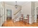 Inviting foyer with hardwood floors, staircase, and elegant lighting fixture at 7801 Wood Way Ct, Raleigh, NC 27606
