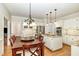 Bright eat-in kitchen with center island, granite counters, and hardwood floors at 7801 Wood Way Ct, Raleigh, NC 27606
