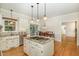 Kitchen with island, granite countertops, stainless steel appliances, and hardwood floors at 7801 Wood Way Ct, Raleigh, NC 27606