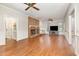 Spacious living room with hardwood floors, brick fireplace, and ceiling fans at 7801 Wood Way Ct, Raleigh, NC 27606