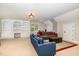 Cozy living room with a built-in bookcase, comfortable seating, and carpeted floor at 7801 Wood Way Ct, Raleigh, NC 27606