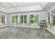 Bright sunroom featuring a beautiful stone floor and large windows with lovely blue patterned curtains at 7801 Wood Way Ct, Raleigh, NC 27606