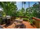 Outdoor deck perfect for relaxation and grilling, surrounded by lush green trees at 9 Lake Village Dr, Durham, NC 27713