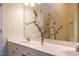 Well-lit bathroom with a double sink vanity, stylish faucet fixtures, and a decorative mirror at 9 Lake Village Dr, Durham, NC 27713