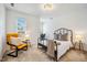 Cozy bedroom features a black metal bed frame, stylish chair, and natural light from the window at 9 Lake Village Dr, Durham, NC 27713