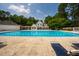 Large community pool with lounge chairs surrounded by trees and a clubhouse, perfect for relaxation at 9 Lake Village Dr, Durham, NC 27713