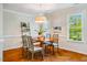 Cozy dining area with hardwood floors, stylish chandelier, and natural light at 9 Lake Village Dr, Durham, NC 27713