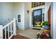 Inviting home entrance with decorative glass door and potted flowers for curb appeal at 9 Lake Village Dr, Durham, NC 27713