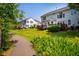 Exterior view of townhomes with well-maintained lawns and private wooden decks at 9 Lake Village Dr, Durham, NC 27713