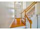 Bright foyer with hardwood floors, a staircase, and a large window above the front door at 9 Lake Village Dr, Durham, NC 27713