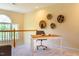 Bright home office area with a desk, chair, and decorative wall art; natural light floods the space at 9 Lake Village Dr, Durham, NC 27713