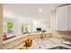 Open kitchen with white cabinets, marble countertops and seamless flow into the living space at 9 Lake Village Dr, Durham, NC 27713
