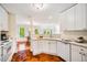 Bright kitchen featuring white cabinets, marble countertops, and open layout to the dining room at 9 Lake Village Dr, Durham, NC 27713