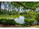 Scenic view of the lake with lush greenery and tree reflections on a clear day at 9 Lake Village Dr, Durham, NC 27713