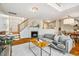 Open living area with fireplace, staircase, and seamless flow to the dining and kitchen at 9 Lake Village Dr, Durham, NC 27713