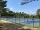 Outdoor pickleball courts surrounded by trees and fencing, offering a recreational community space at 9 Lake Village Dr, Durham, NC 27713