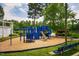Community playground with slide and climbing structure next to a lake at 9 Lake Village Dr, Durham, NC 27713