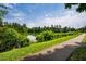Beautiful view of a lake with walking path and lush green vegetation under a partly cloudy sky at 9 Lake Village Dr, Durham, NC 27713