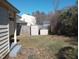 Fenced backyard featuring two storage sheds and a mix of grass and ground cover at 912 Dixie Trl, Raleigh, NC 27607