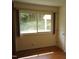 Bright bedroom with hardwood floors and a large window overlooking the backyard at 912 Dixie Trl, Raleigh, NC 27607