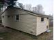 Side view of a one story home featuring vinyl siding and well-placed windows for natural light at 912 Dixie Trl, Raleigh, NC 27607