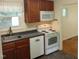 Kitchen features white appliances and ample cabinet space with dark countertops at 912 Dixie Trl, Raleigh, NC 27607