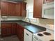Bright kitchen with updated countertops, wooden cabinets, and essential appliances for cooking at 912 Dixie Trl, Raleigh, NC 27607