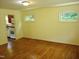 Bright living room with hardwood floors, large windows and connection to the kitchen at 912 Dixie Trl, Raleigh, NC 27607