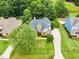 Aerial view of a well-maintained home with a long driveway and a lush, green lawn at 921 Riverwood Dr, Clayton, NC 27527