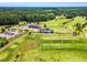 Breathtaking aerial view of a golf course and club house with manicured lawns and fairways at 921 Riverwood Dr, Clayton, NC 27527