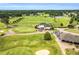 Stunning aerial view of a golf course and club house with manicured lawns and golf carts at 921 Riverwood Dr, Clayton, NC 27527