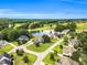 Scenic aerial view of a luxury home nestled within a golf course and overlooking a serene pond at 921 Riverwood Dr, Clayton, NC 27527