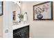 Modern bathroom featuring a dark vanity, quartz countertop, round mirror, and stylish fixtures at 921 Riverwood Dr, Clayton, NC 27527