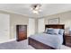 Cozy bedroom featuring a warm color scheme, ceiling fan, and wood furnishings at 921 Riverwood Dr, Clayton, NC 27527