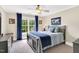 Cozy bedroom with blue accents, a large window offering a green view, and a comfortable, inviting atmosphere at 921 Riverwood Dr, Clayton, NC 27527