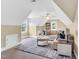 Spacious bonus room features plush seating, blue accents, and abundant natural light at 921 Riverwood Dr, Clayton, NC 27527