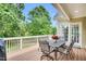 Inviting outdoor deck with a metal table and chairs, providing serene views of the surrounding greenery at 921 Riverwood Dr, Clayton, NC 27527