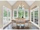 Dining room boasts natural light from large windows and exterior doors with views of the surrounding greenery at 921 Riverwood Dr, Clayton, NC 27527