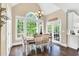 Charming dining room with a vaulted ceiling, large window views, and an adjacent door to the exterior at 921 Riverwood Dr, Clayton, NC 27527