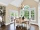 Bright dining room featuring a chandelier, large windows offering scenic outdoor views, and a dining set at 921 Riverwood Dr, Clayton, NC 27527
