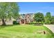 Charming two-story brick home with manicured lawn, mature trees, and classic curb appeal at 921 Riverwood Dr, Clayton, NC 27527